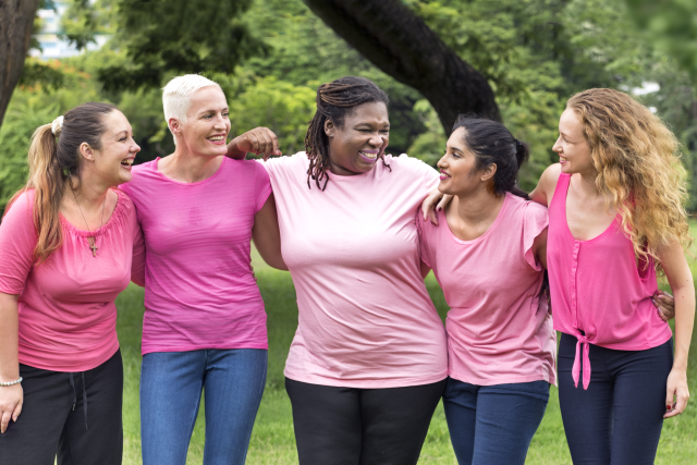Breast cancer survivors standing strong together