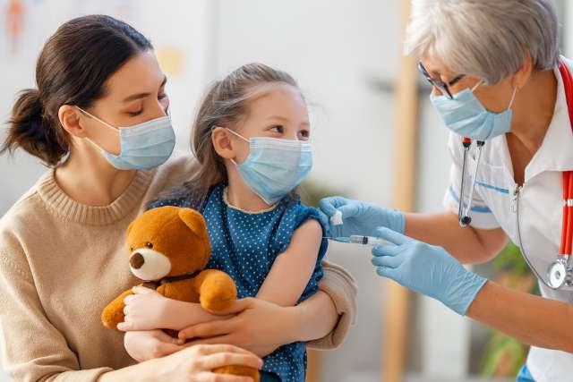 Doctor vaccinating child